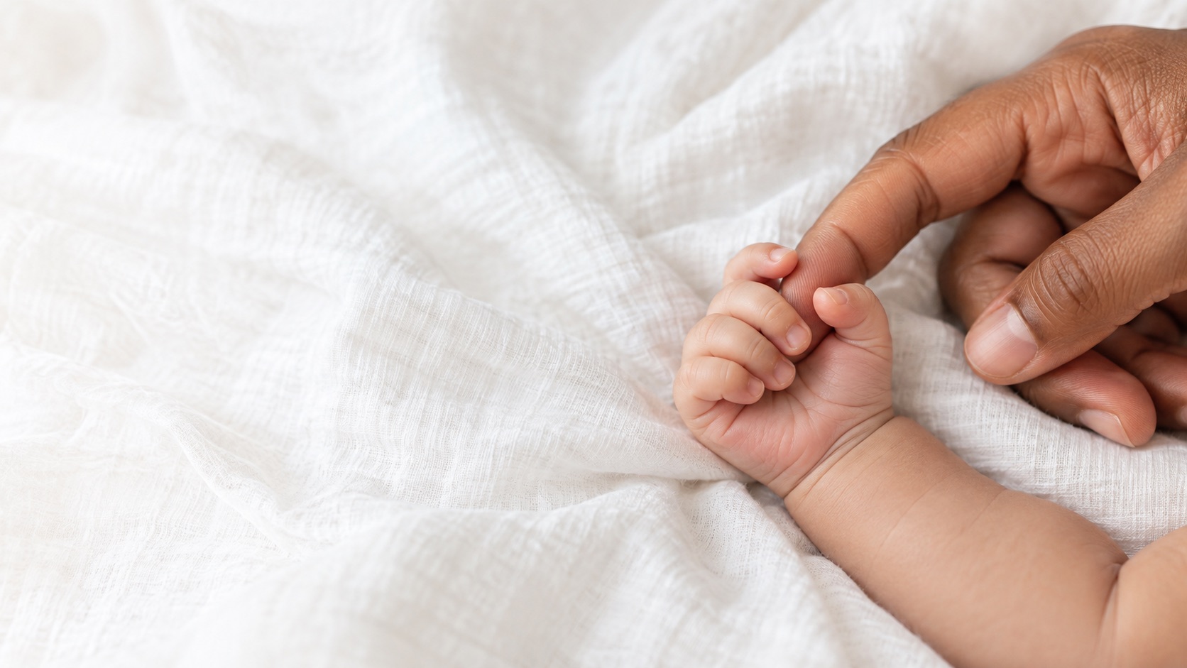 Conceptual illustration of an infant hand holding an adult finger